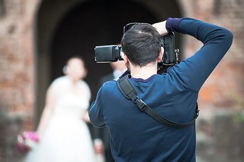Wedding photographer using flashgun