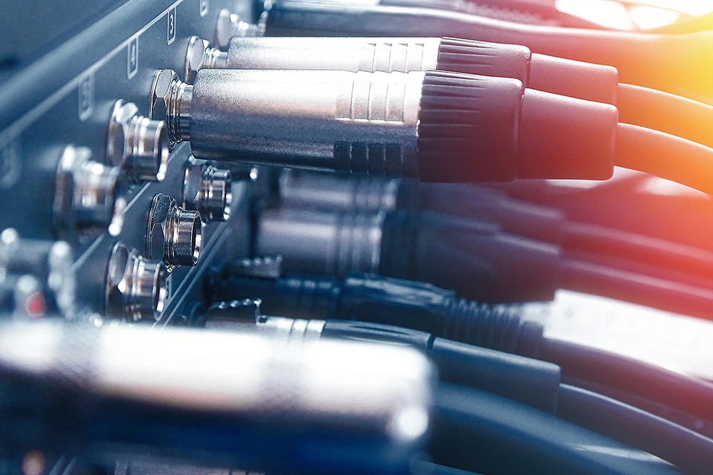 Close-up of multiple XLR audio cables plugged into a professional audio interface